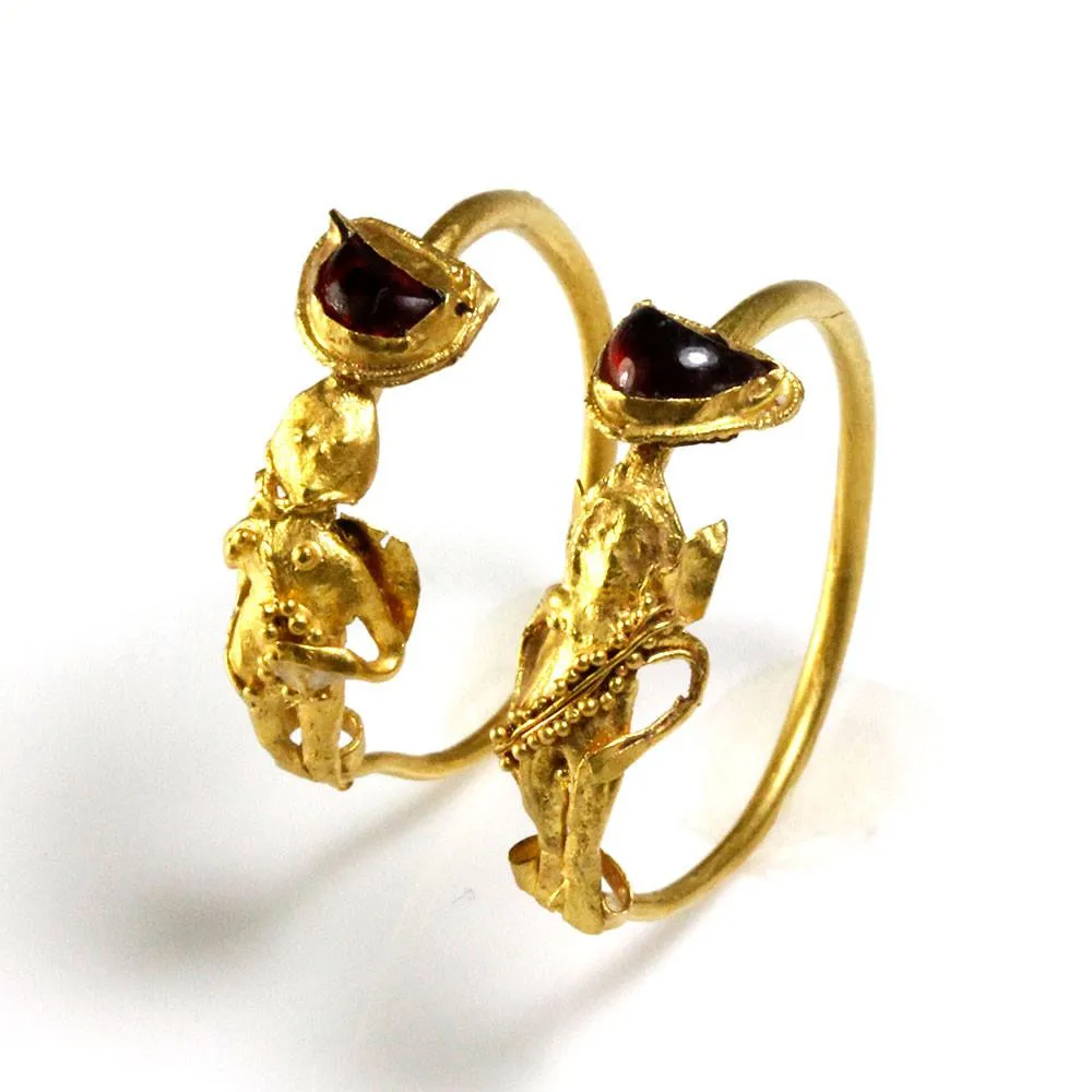 A Pair of Gold & Garnet Earrings of Eros, Hellenistic Period, ca. 2nd - 1st century BCE